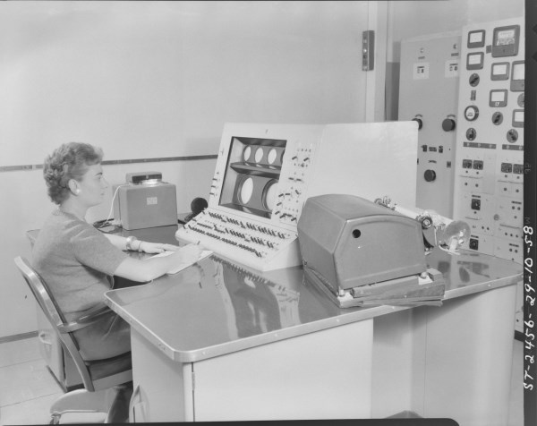 The main console. I believe the console operator is Rita Lahey but this has yet to be confirmed. The Creed photo-tape reader is on the left of the console and the Creed printer is on the right. Photo courtesy of the NRC Archives.